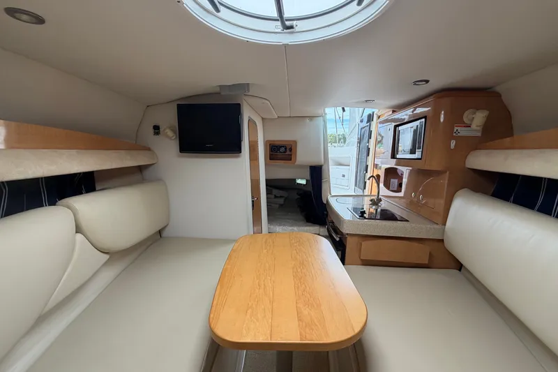 Slide: The Image of Interior of 2011 Four Winns V285 boat with seating, table, and kitchenette. - 79