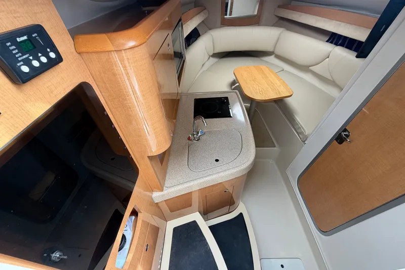 Slide: The Image of Interior of 2011 Four Winns V285 boat with kitchenette and seating area. - 44