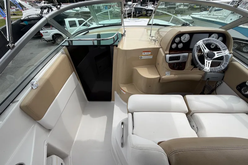 Slide: The Image of Interior view of 2011 Four Winns V285 boat cockpit with steering wheel and seating. - 16