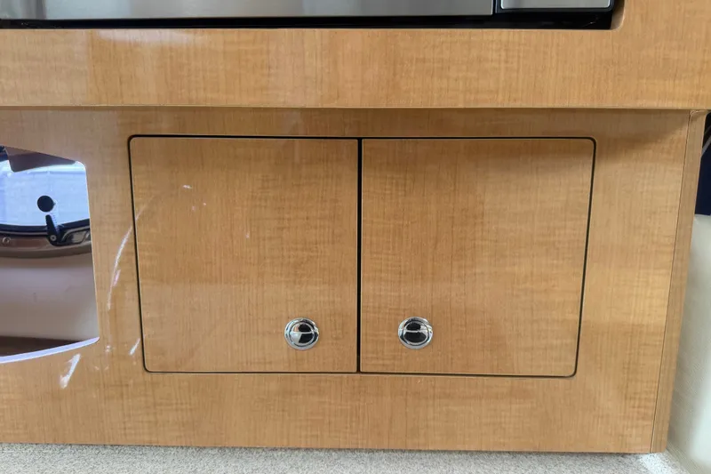 Slide: The Image of Wooden cabinet doors on a 2011 Four Winns V285 boat interior. - 60