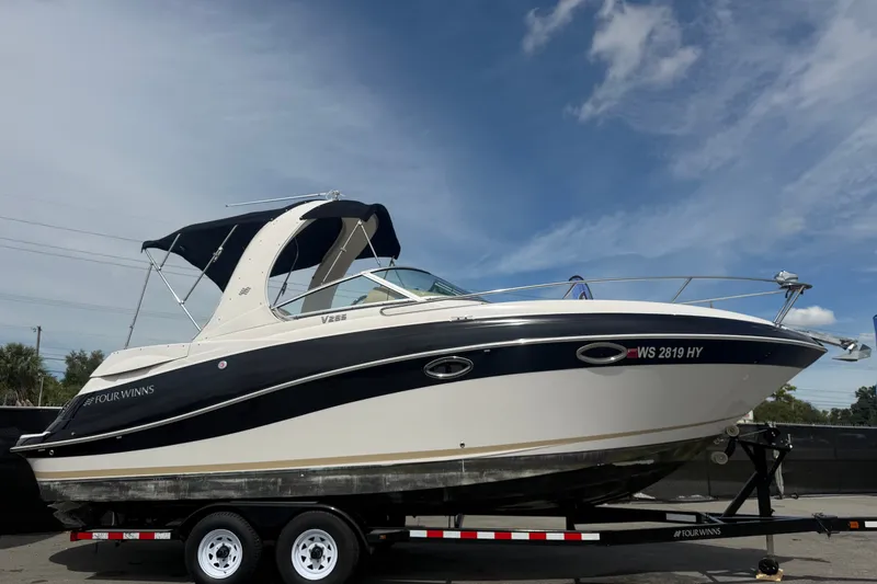 Slide: The Image of 2011 Four Winns V285 boat on trailer under clear blue sky. - 1
