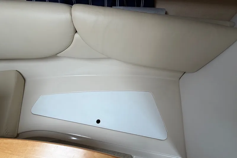Slide: The Image of Interior seating of 2011 Four Winns V285 boat, featuring beige upholstery and sleek design. - 77