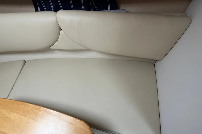 Slide: The Image of Cream leather seating and wooden table in 2011 Four Winns V285 boat interior. - 76