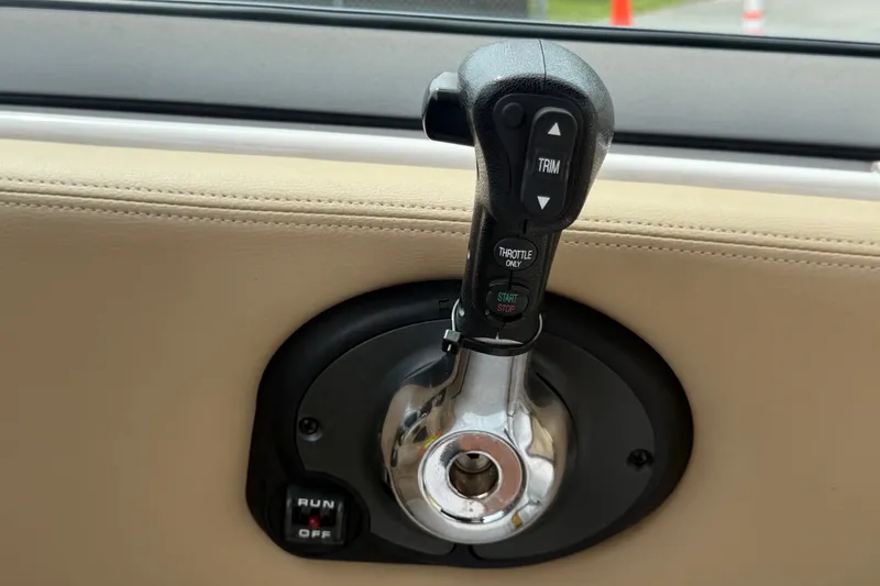 Slide: The Image of Throttle control lever on a 2011 Four Winns V285 boat dashboard. - 30