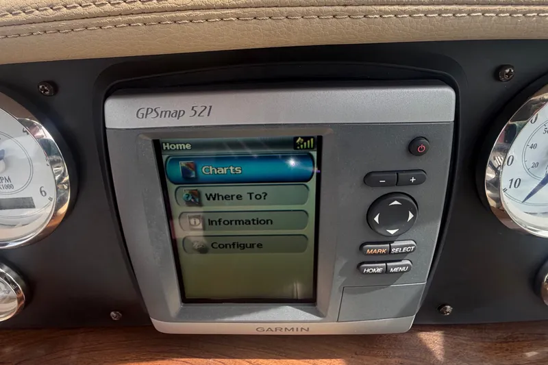 Slide: The Image of A Garmin GPSmap 521 navigation system is integrated into a boat's dashboard. - 24