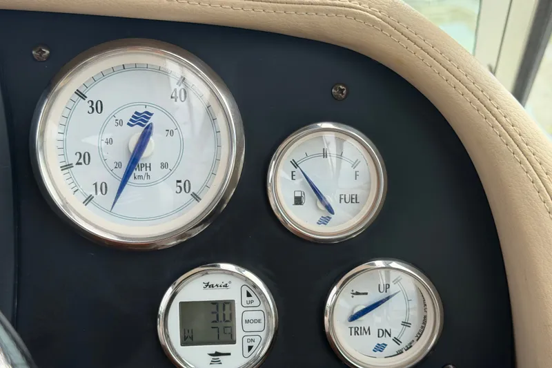 Slide: The Image of Dashboard of 2011 Four Winns V285 boat with speedometer, fuel, and trim gauges. - 25