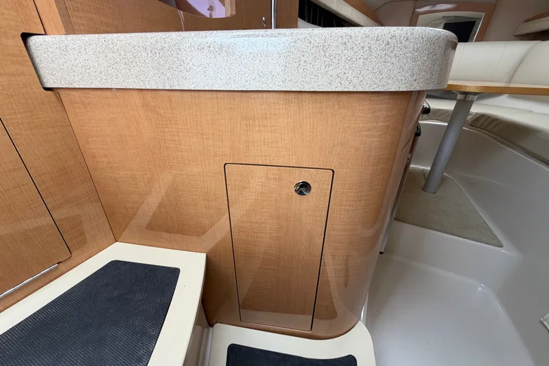 Slide: The Image of Interior view of 2011 Four Winns V285 boat, featuring wood cabinetry and countertop. - 54