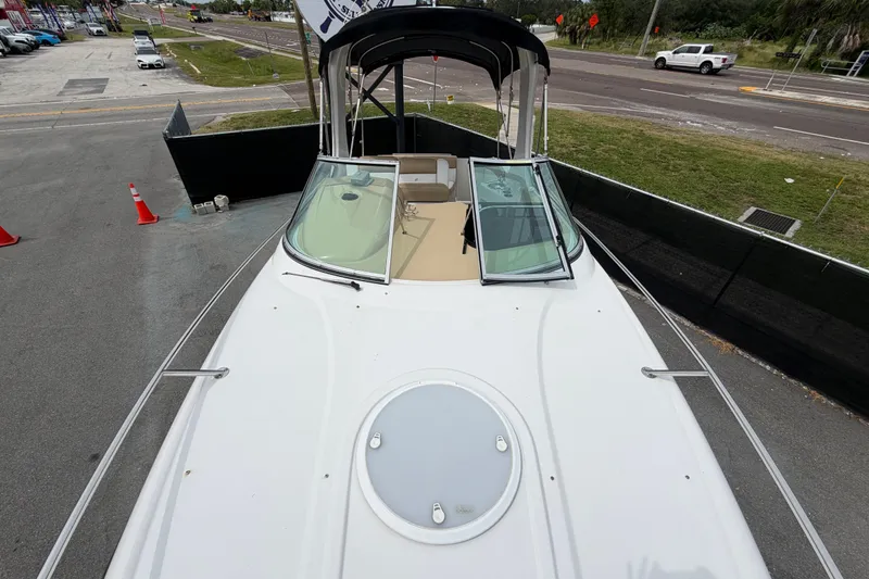 Slide: The Image of 2011 Four Winns V285 boat with open deck and windshield, parked on pavement. - 38