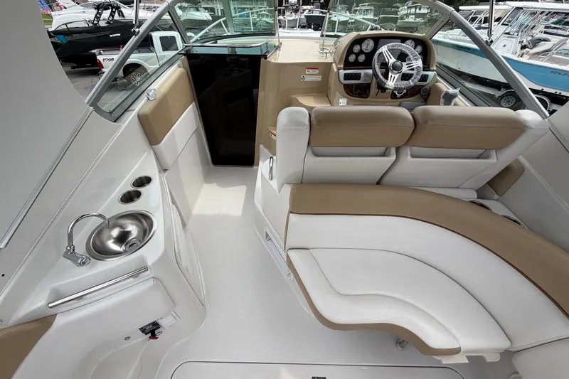 Slide: The Image of Interior of 2011 Four Winns V285 boat with helm, seating, and sink. - 12