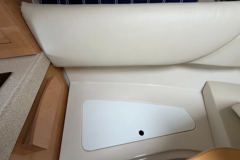 Slide: The Image of Interior seating area of a 2011 Four Winns V285 boat, featuring beige upholstery. - 71