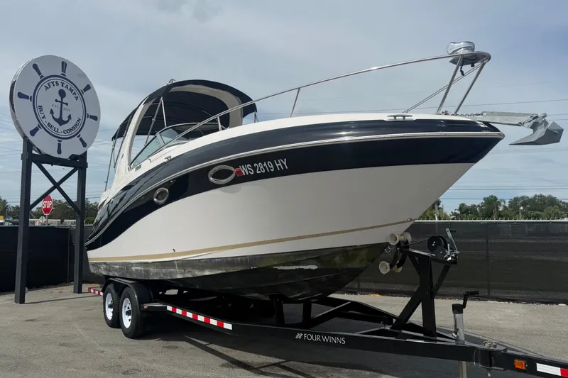 Slide: The Image of 2011 Four Winns V285 boat on trailer at dealership, ready for sale. - 0
