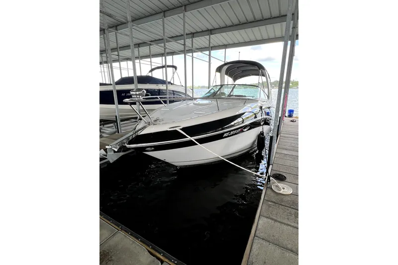 Slide: The Image of 2011 Four Winns V285 boat docked in a covered marina slip. - 1