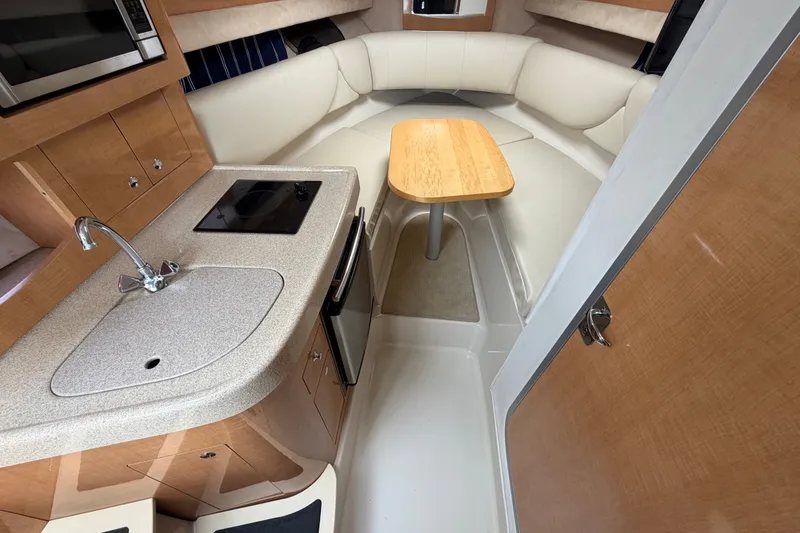 Slide: The Image of Interior of 2011 Four Winns V285 boat with kitchenette and seating area. - 45