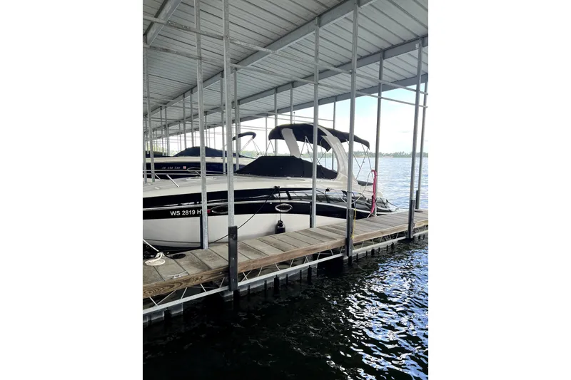 Slide: The Image of 2011 Four Winns V285 boat docked under a covered marina. - 3