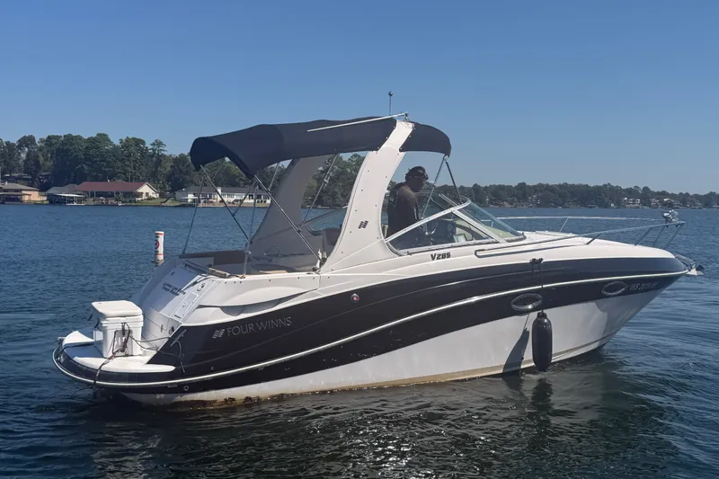 Slide: The Image of 2011 Four Winns V285 boat on a lake with a canopy and scenic background. - 119