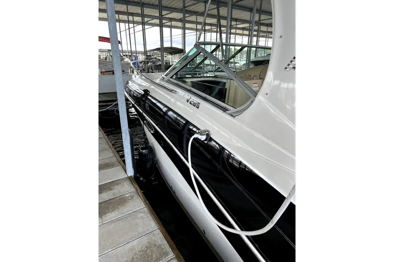 Slide: The Image of 2011 Four Winns V285 boat docked in a marina, side view. - 4