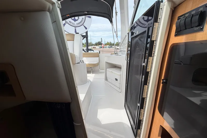 Slide: The Image of Interior view of 2011 Four Winns V285 boat, showcasing seating and cabin entrance. - 100