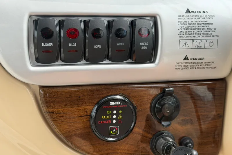 Slide: The Image of Control panel of a 2011 Four Winns V285 boat with switches and gas detector. - 26