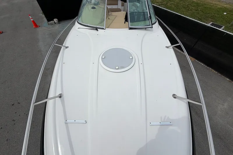 Slide: The Image of 2011 Four Winns V285 boat deck with railing and hatch, docked on pavement. - 37