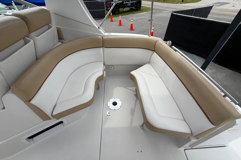 Slide: The Image of 2011 Four Winns V285 boat interior with beige and white seating arrangement. - 10