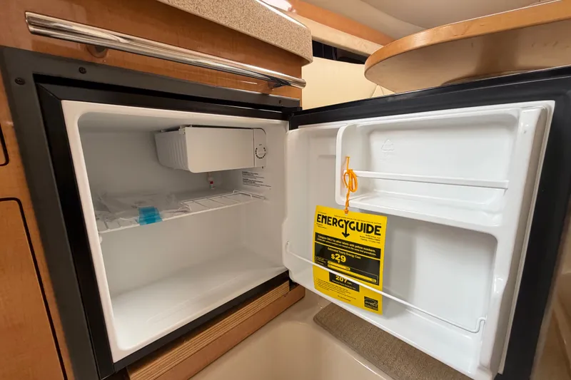 Slide: The Image of Open refrigerator in 2011 Four Winns V285 boat, displaying EnergyGuide label. - 67
