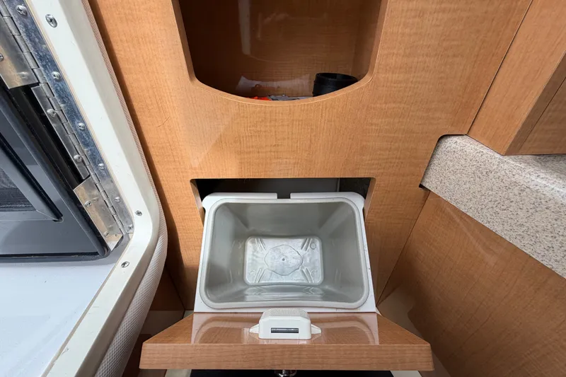Slide: The Image of Interior of 2011 Four Winns V285 boat showing a built-in storage compartment. - 53