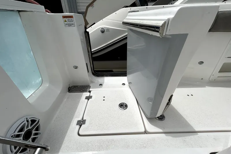 Slide: The Image of 2024 Sea Fox 328 Commander boat deck with storage compartments and seating area. - 72