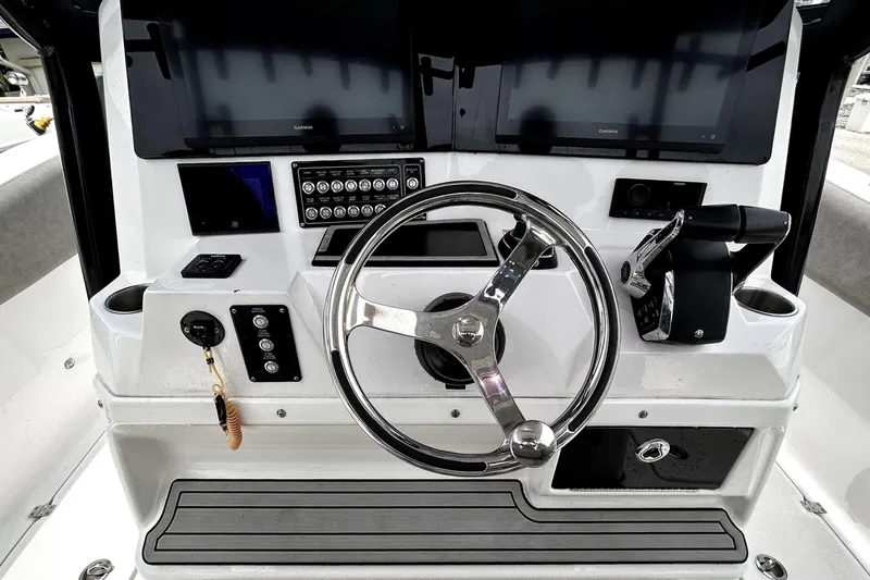 Slide: The Image of 2024 Sea Fox 328 Commander helm with steering wheel and control panel. - 29