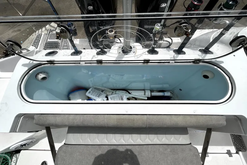 Slide: The Image of 2024 Sea Fox 328 Commander boat interior with storage compartment and fishing rod holders. - 75