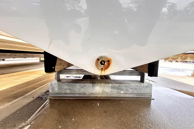 Slide: The Image of 2024 Sea Fox 328 Commander hull on a trailer, showing a drain plug. - 86