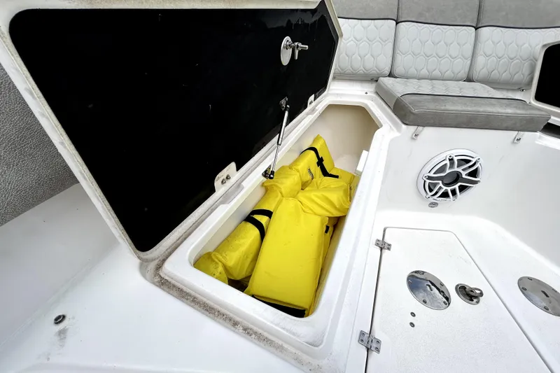 Slide: The Image of Storage compartment with yellow life jackets on a 2024 Sea Fox 328 Commander boat. - 54