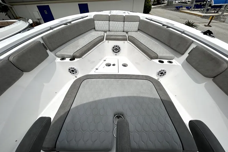 Slide: The Image of 2024 Sea Fox 328 Commander boat interior with gray cushioned seating and speakers. - 50