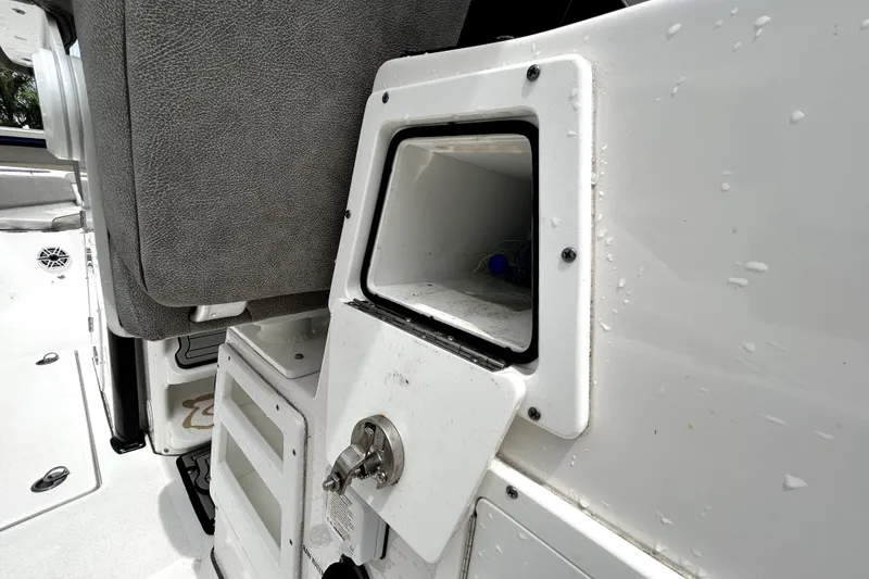 Slide: The Image of 2024 Sea Fox 328 Commander boat storage compartment with water droplets and seating detail. - 41