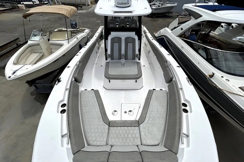 Slide: The Image of 2024 Sea Fox 328 Commander boat with spacious seating, docked alongside other boats. - 59