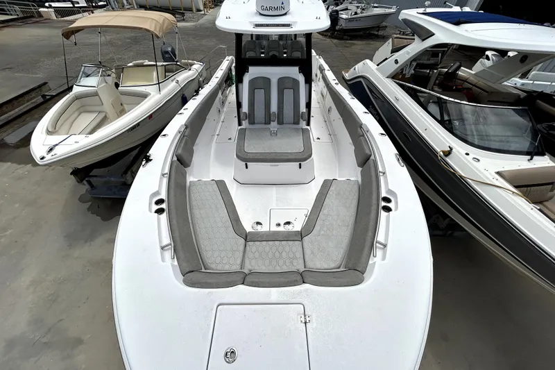 Slide: The Image of 2024 Sea Fox 328 Commander boat with spacious seating, docked alongside other boats. - 58