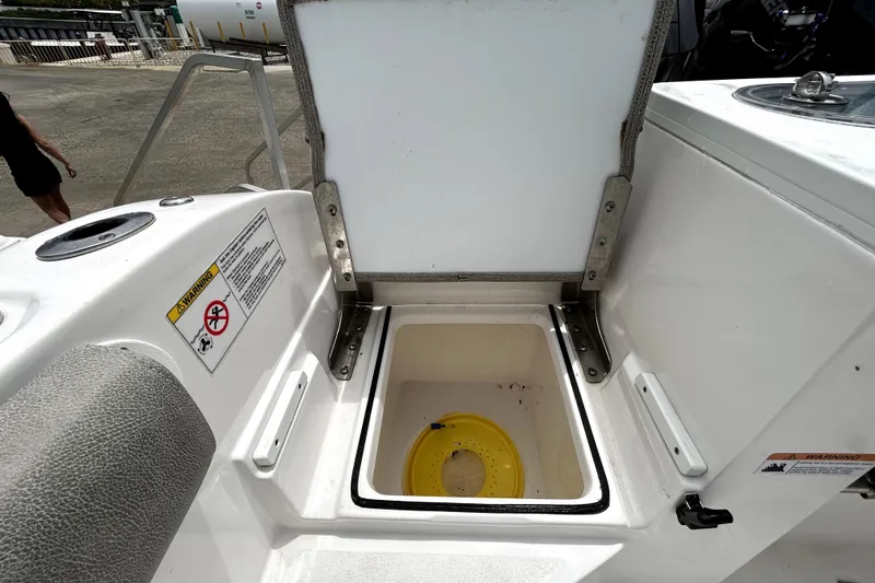Slide: The Image of Open storage compartment on 2024 Sea Fox 328 Commander boat, featuring safety warnings. - 78