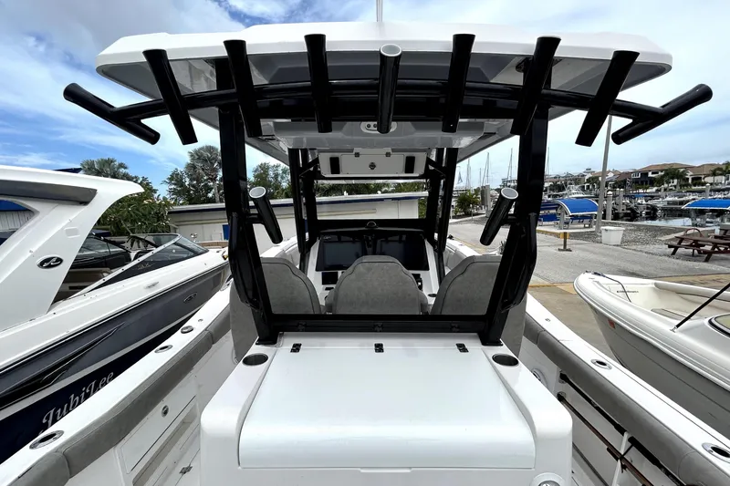 Slide: The Image of 2024 Sea Fox 328 Commander boat docked at marina, showcasing helm and seating area. - 20
