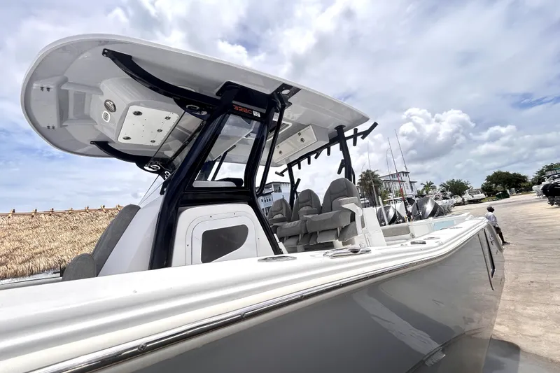 Slide: The Image of 2024 Sea Fox 328 Commander boat with sleek design and modern features, docked under a cloudy sky. - 18