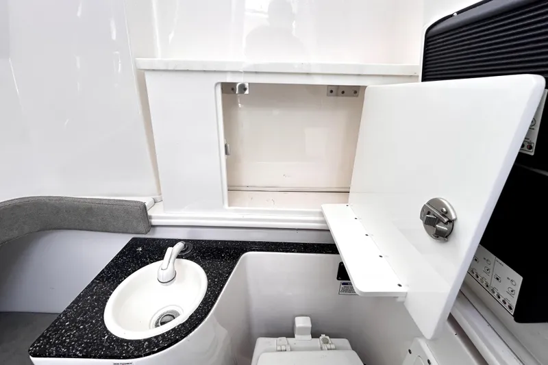 Slide: The Image of 2024 Sea Fox 328 Commander interior with sink and storage compartment. - 46