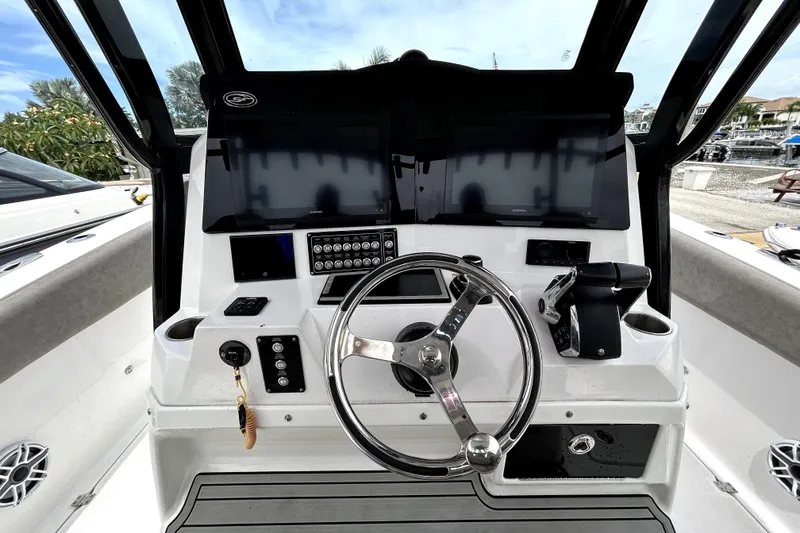 Slide: The Image of 2024 Sea Fox 328 Commander helm with dual screens and modern controls. - 28