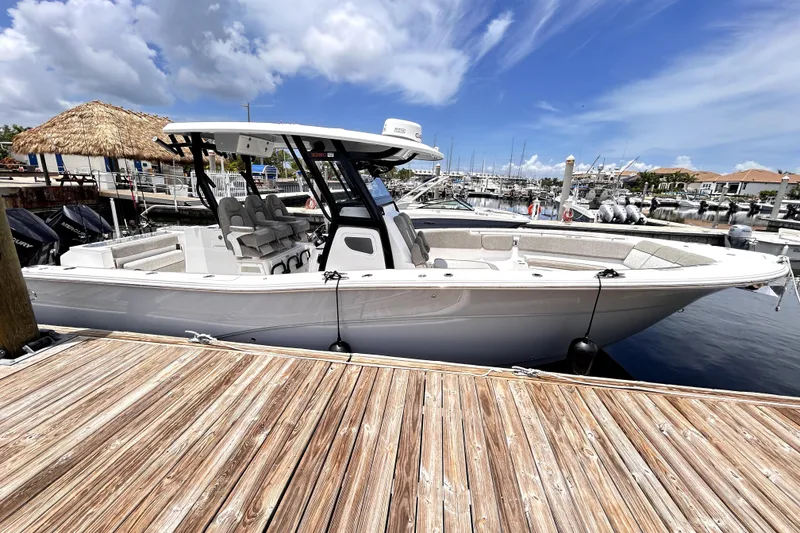 Slide: The Image of 2024 Sea Fox 328 Commander boat docked at marina under clear blue sky. - 16