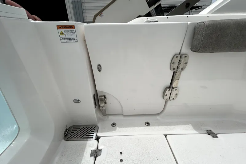 Slide: The Image of 2024 Sea Fox 328 Commander boat interior with hinged compartment and warning label. - 73