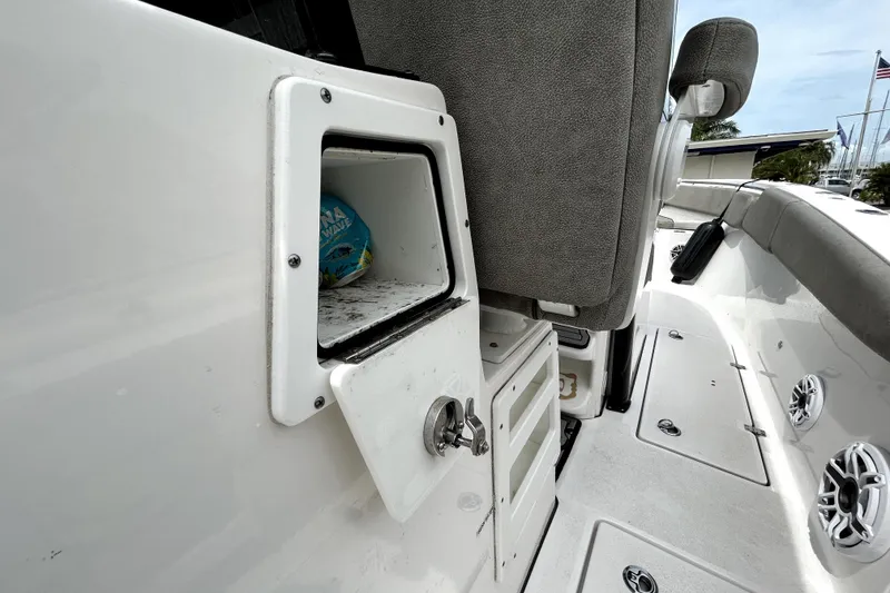 Slide: The Image of 2024 Sea Fox 328 Commander boat interior storage compartment with seating and speakers. - 42