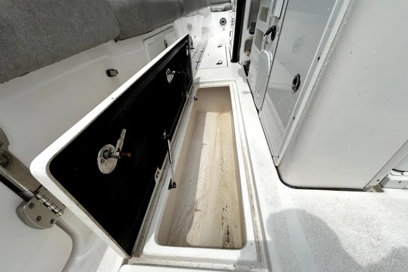 Slide: The Image of 2024 Sea Fox 328 Commander storage compartment with open hatch, showcasing spacious interior. - 25