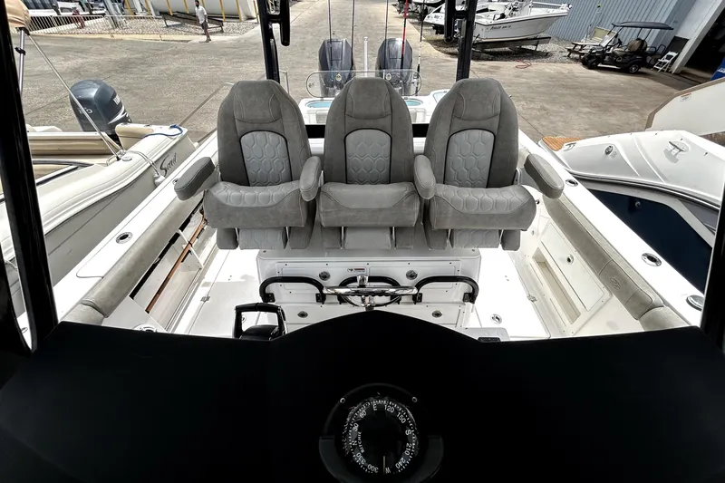Slide: The Image of 2024 Sea Fox 328 Commander boat interior with three cushioned seats and steering console. - 66