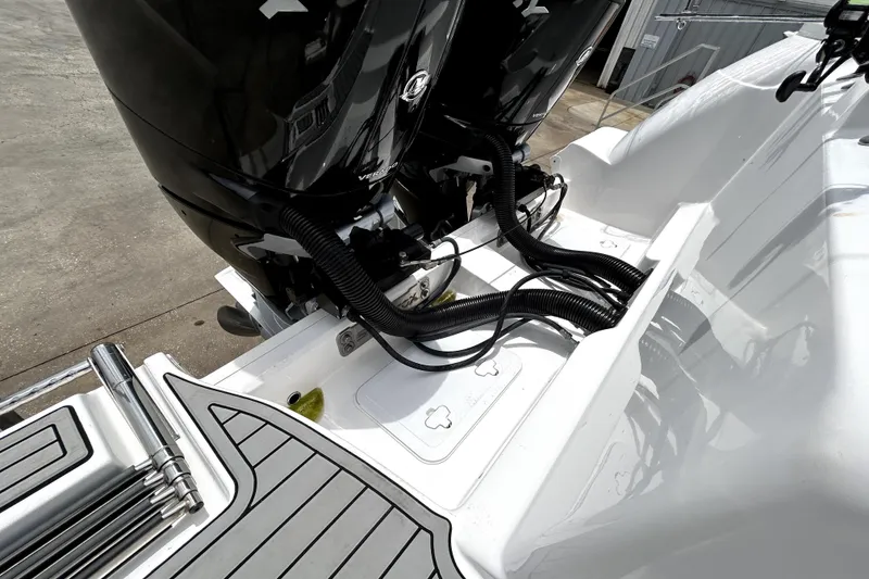 Slide: The Image of 2024 Sea Fox 328 Commander boat engine area with dual motors and sleek design. - 81