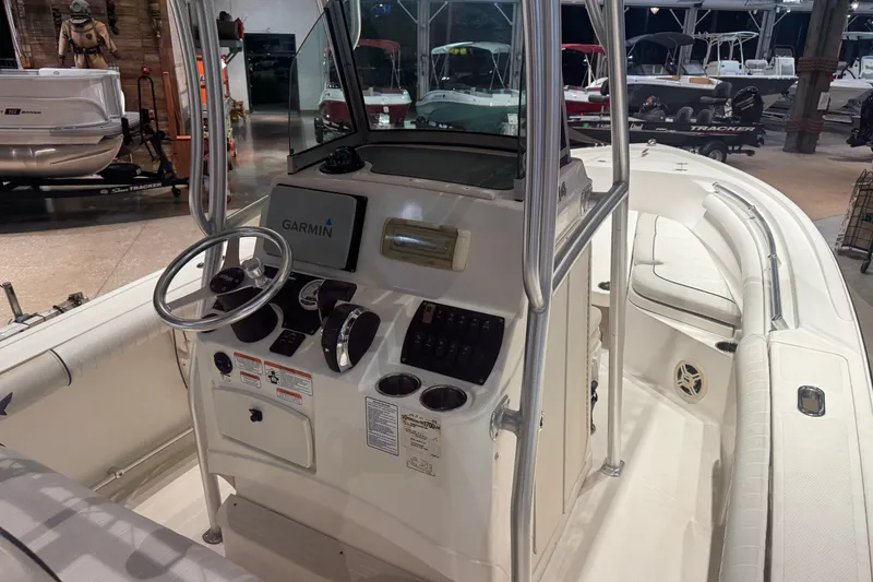 Slide: The Image of 2015 Mako 214 Center Console boat interior with Garmin navigation system and steering wheel. - 6