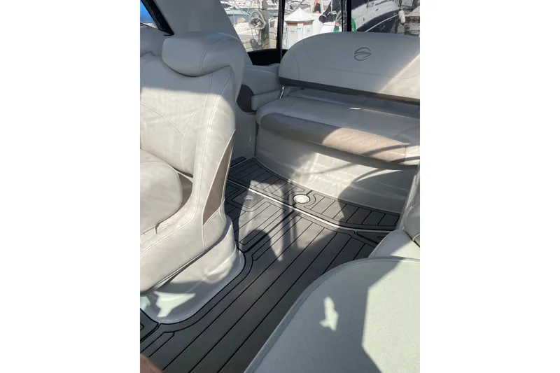 Slide: The Image of Interior of a 2012 Crownline 260 CR boat with beige seating and patterned flooring. - 7