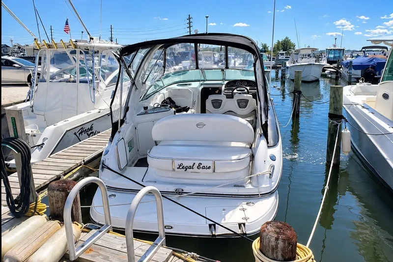 Slide: The Image of 2012 Crownline 260 CR boat docked at marina, sunny day, clear blue sky. - 3