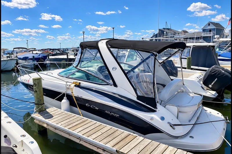 Slide: The Image of 2012 Crownline 260 CR boat docked at marina under clear blue sky. - 1
